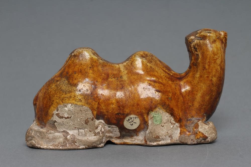 A SMALL TANG STYLE RECUMBENT CAMEL, with museum style/collectors number K61/1706 inscribed in black, Image