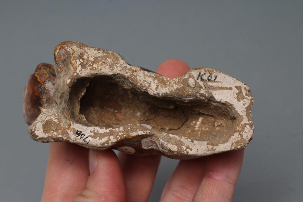 A SMALL TANG STYLE RECUMBENT CAMEL, with museum style/collectors number K61/1706 inscribed in black, Image