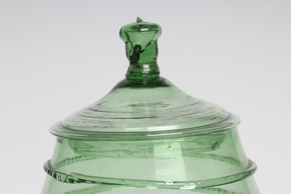 A GERMAN GREEN DAUMENGLAS OR THUMB GLASS AND COVER Image