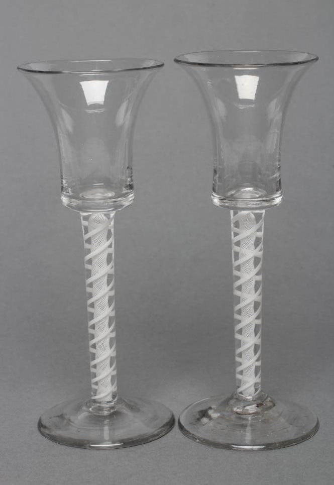 A PAIR OF CORDIAL GLASSES, mid 18th century, the bell bowls on opaque twist stems with a central Image