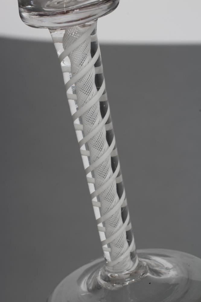 A PAIR OF CORDIAL GLASSES, mid 18th century, the bell bowls on opaque twist stems with a central Image