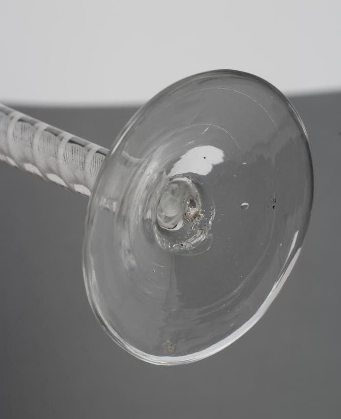 A PAIR OF CORDIAL GLASSES, mid 18th century, the bell bowls on opaque twist stems with a central Image