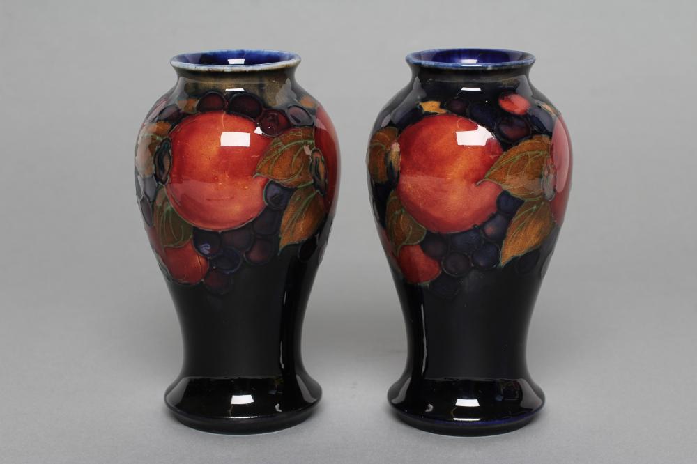 A PAIR OF MOORCROFT POTTERY POMEGRANATE PATTERN VASES Image
