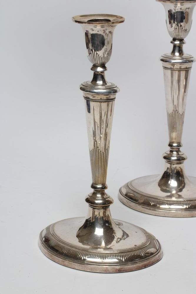 A PAIR OF EDWARDIAN PLATED ON COPPER TWO BRANCH CANDELABRA Image