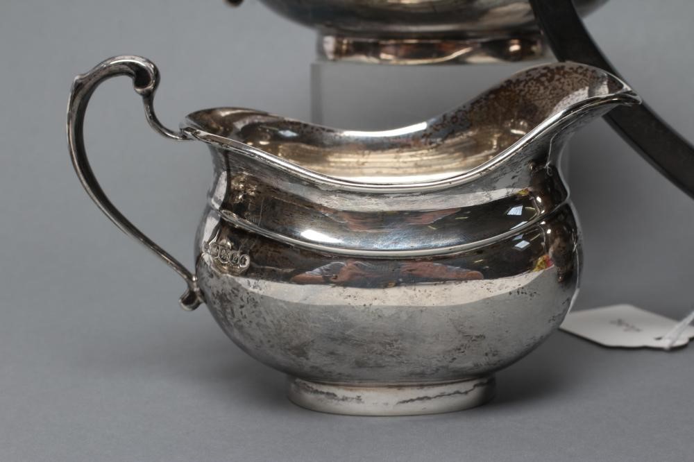 A SILVER TEAPOT AND COFFEE POT Image