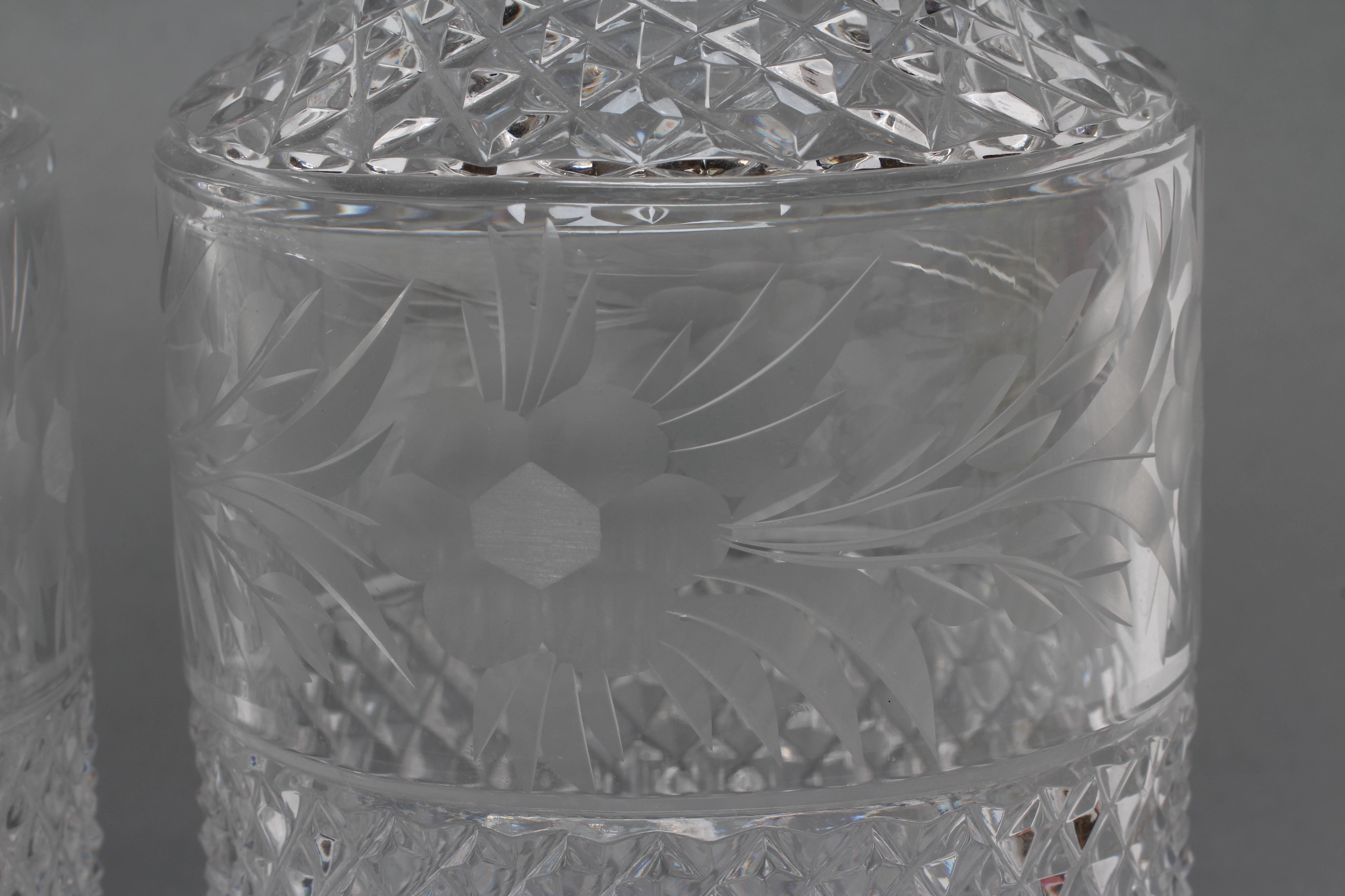 A PAIR OF SILVER MOUNTED TRIPLE RING NECK GLASS MALLET DECANTERS AND STOPPERS with diamond moulded Image