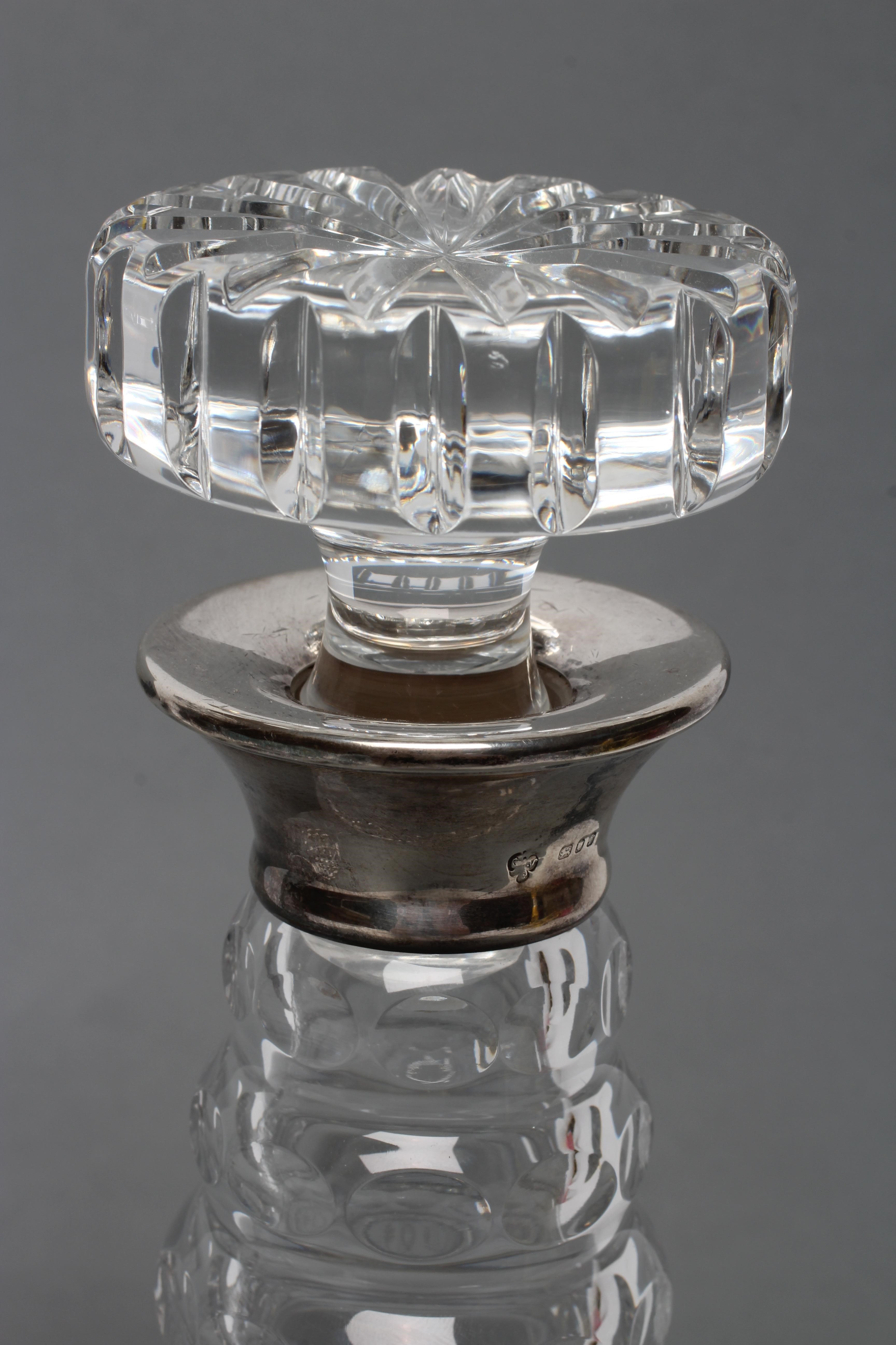 A PAIR OF SILVER MOUNTED TRIPLE RING NECK GLASS MALLET DECANTERS AND STOPPERS with diamond moulded Image