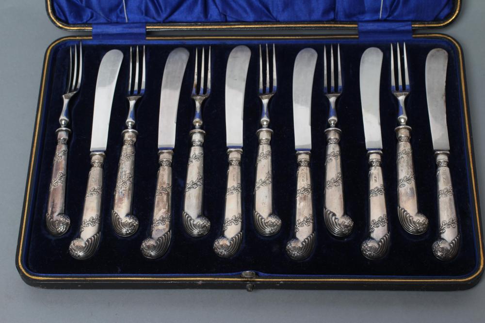 AN EDWARDIAN SET OF SIX PAIRS OF SILVER DESSERT KNIVES AND FORKS Image