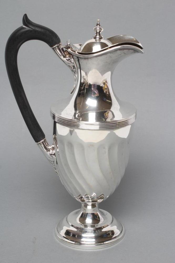 A LATE VICTORIAN SILVER CLARET JUG Image