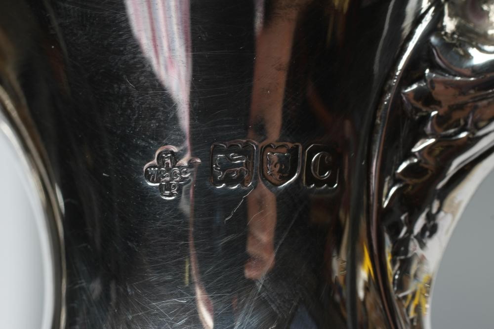 A LATE VICTORIAN SILVER CLARET JUG Image