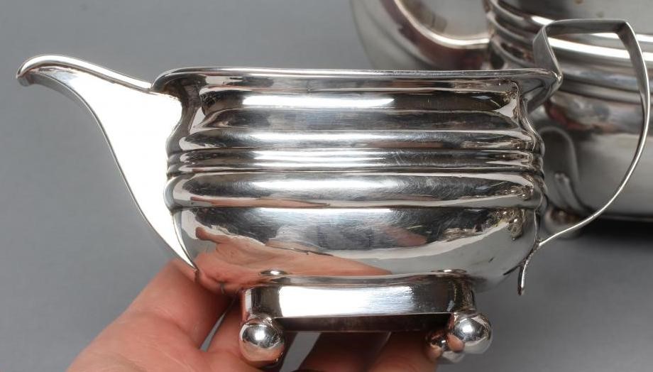 A LATE GEORGE III SILVER TEAPOT Image