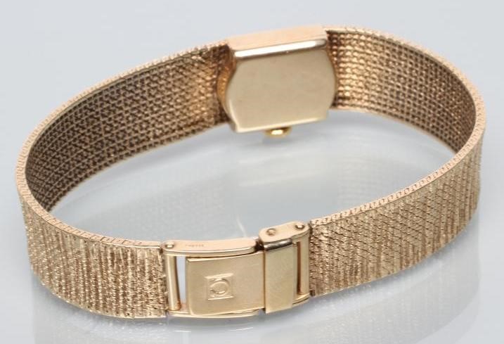 A LADY'S 9CT GOLD OMEGA WRISTWATCH Image