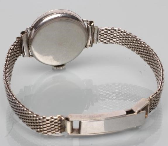 A DIAMOND AND PLATINUM COCKTAIL WATCH Image
