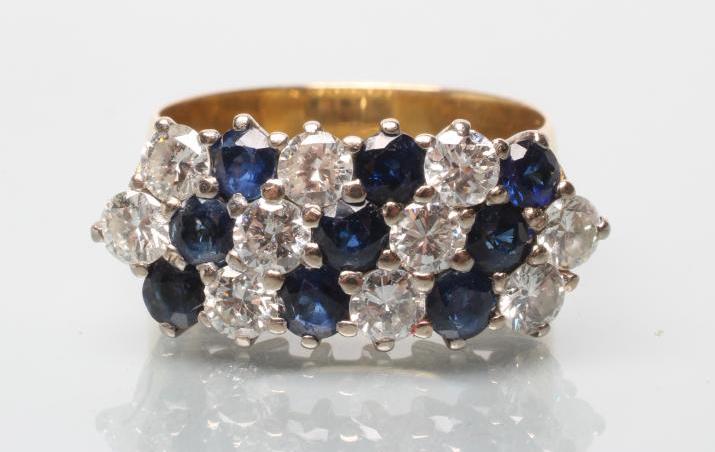 A DIAMOND AND SAPPHIRE HALF HOOP RING Image