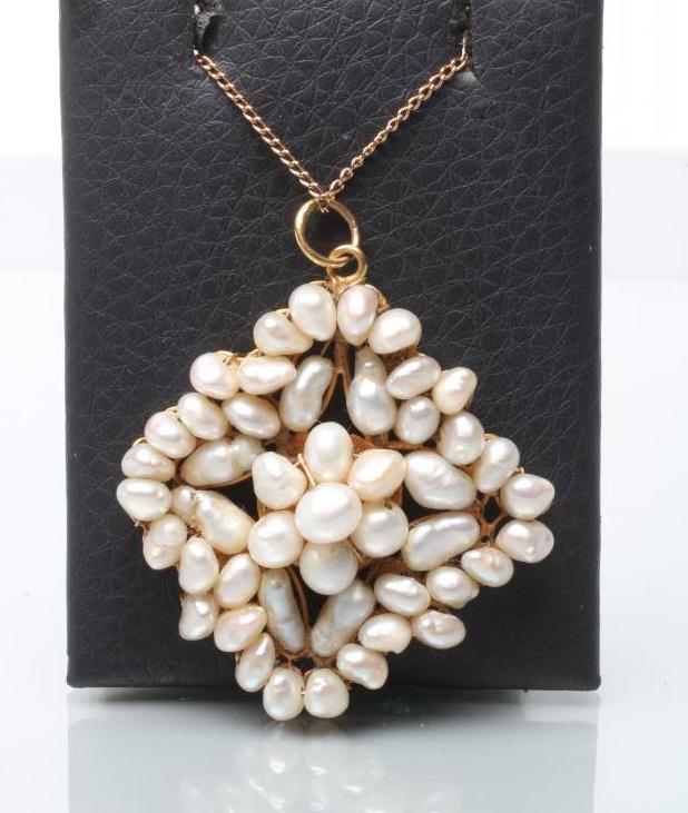 A FRESHWATER PEARL PENDANT of open quatrefoil form Image