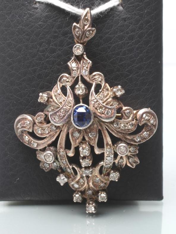 A VICTORIAN SAPPHIRE AND DIAMOND BROOCH/PENDANT of stylised anthemion form Image
