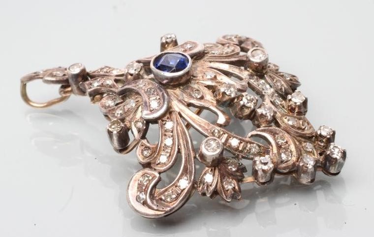 A VICTORIAN SAPPHIRE AND DIAMOND BROOCH/PENDANT of stylised anthemion form Image