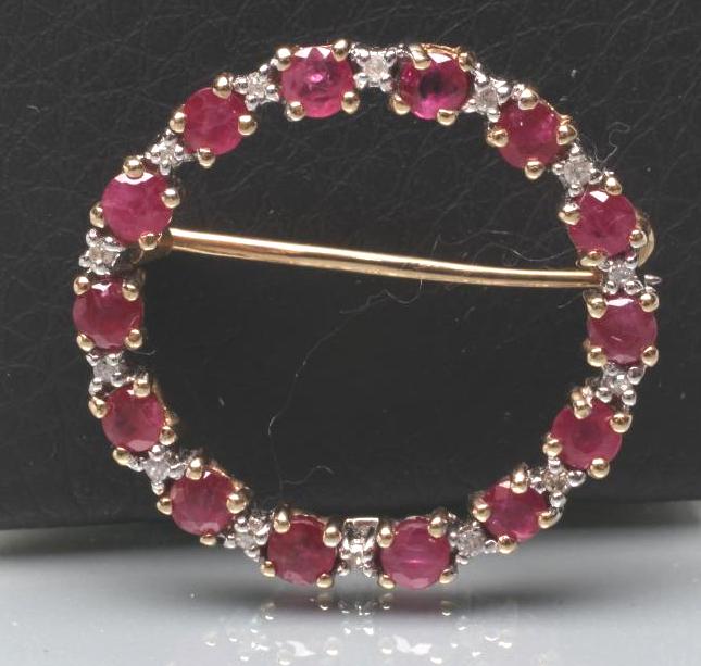 A RUBY AND DIAMOND CIRCLET BROOCH Image