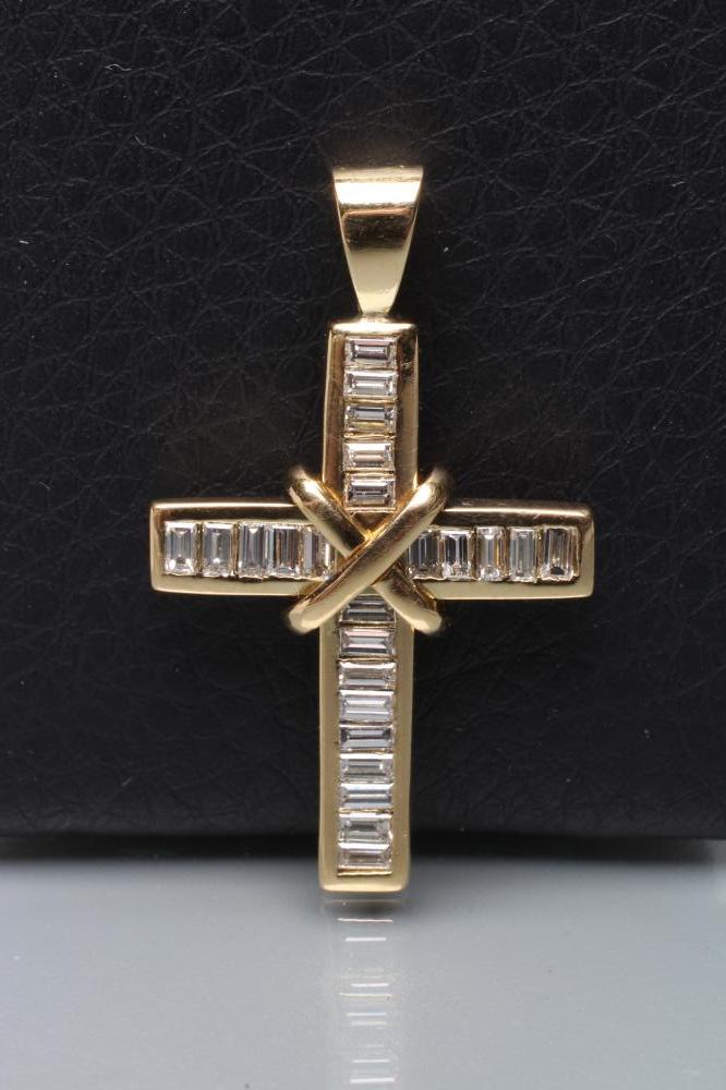 A DIAMOND CROSS PENDANT channel set with baguette cut stones Image