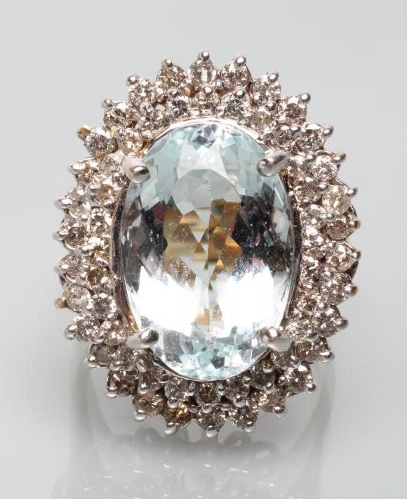 A LARGE AQUAMARINE AND DIAMOND CLUSTER RING Image