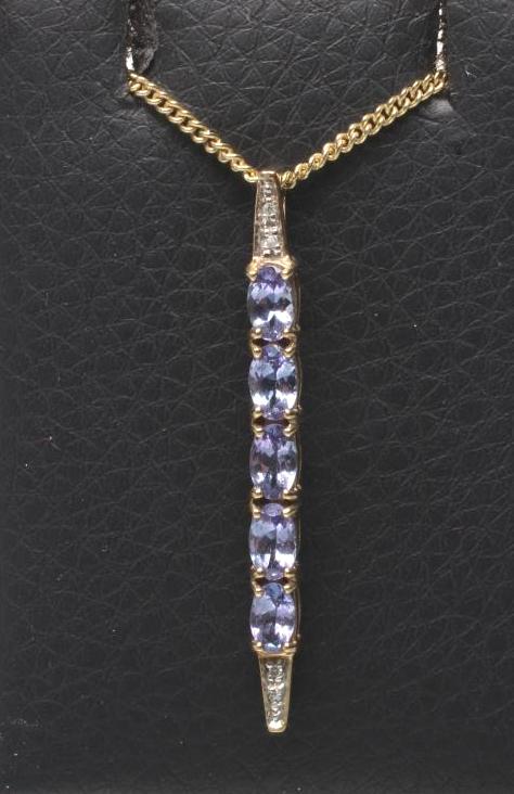 A TANZANITE AND DIAMOND LINE PENDANT Image