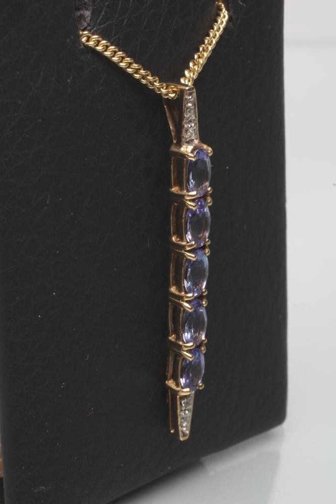 A TANZANITE AND DIAMOND LINE PENDANT Image