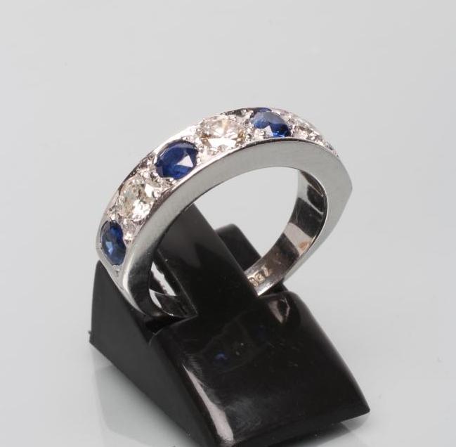 A SEVEN STONE DIAMOND AND SAPPHIRE HALF HOOP ETERNITY RING Image