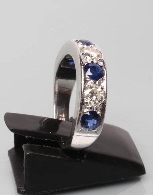 A SEVEN STONE DIAMOND AND SAPPHIRE HALF HOOP ETERNITY RING Image