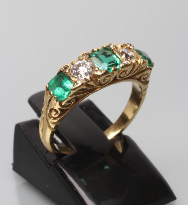 A FIVE STONE EMERALD AND DIAMOND HALF HOOP RING Image