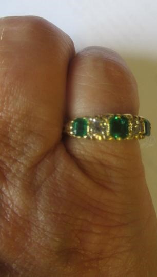 A FIVE STONE EMERALD AND DIAMOND HALF HOOP RING Image