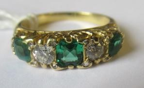 A FIVE STONE EMERALD AND DIAMOND HALF HOOP RING Image