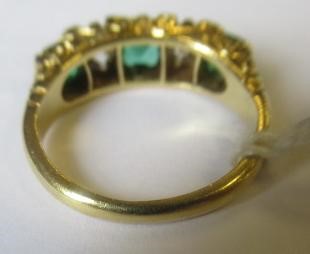 A FIVE STONE EMERALD AND DIAMOND HALF HOOP RING Image
