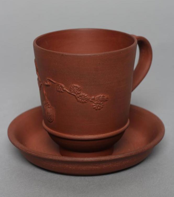 AN ELERS TYPE REDWARE CAPPUCINE AND SAUCER Image