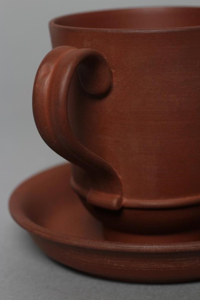 AN ELERS TYPE REDWARE CAPPUCINE AND SAUCER Image