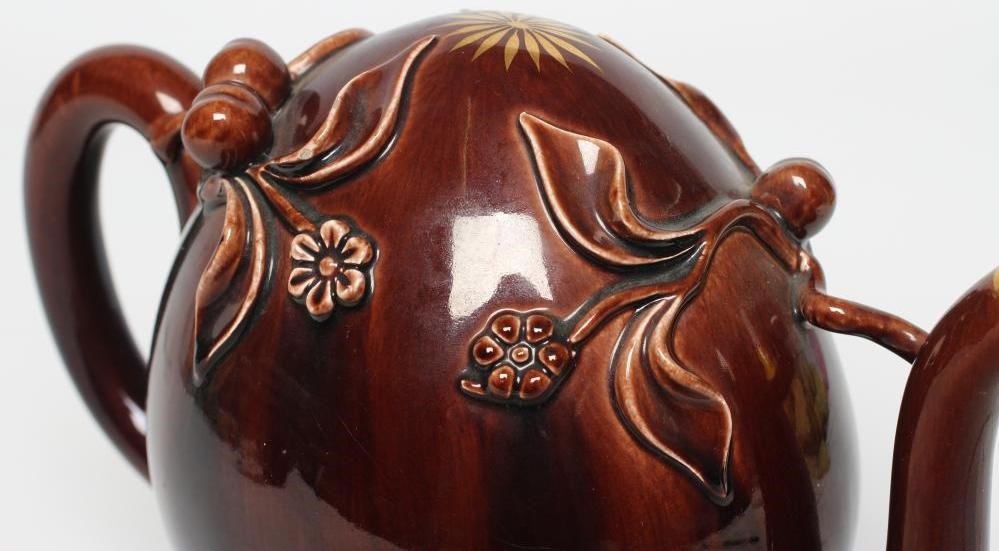 A ROCKINGHAM BROWN GLAZED STONEWARE CADOGAN TEAPOT Image