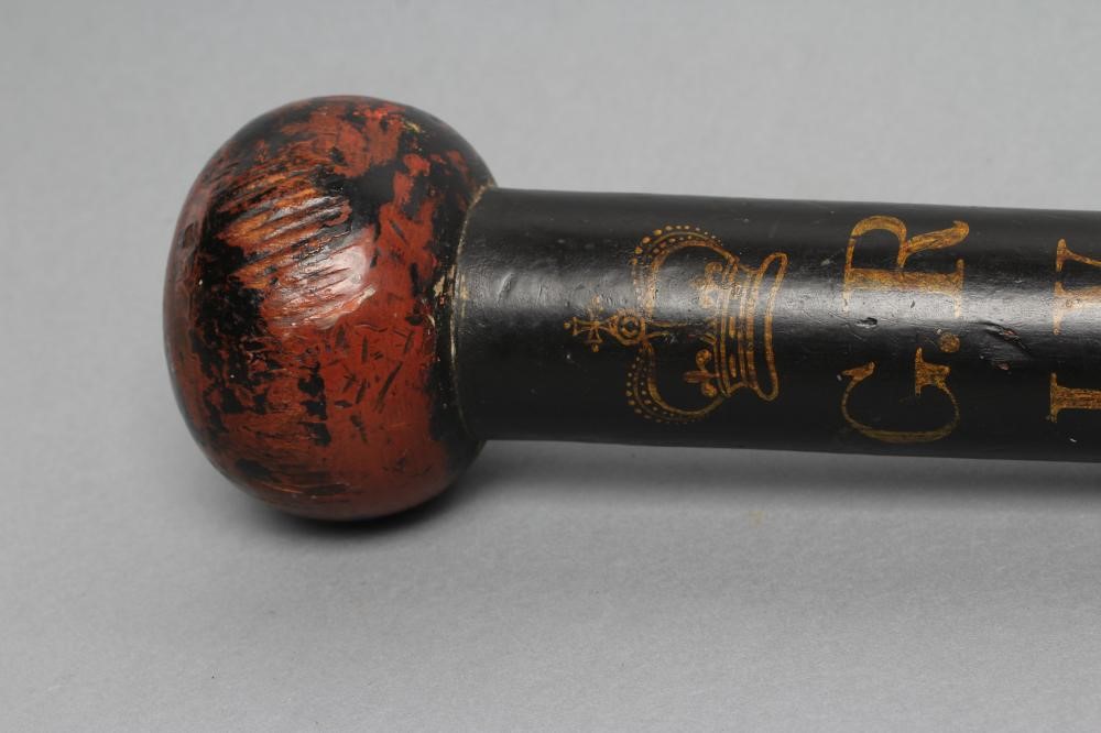 A POLICE TRUNCHEON of knobkerrie form with bulbous head painted in black and red Image