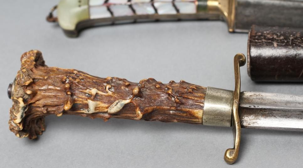 THREE SHEATHED DAGGERS Image