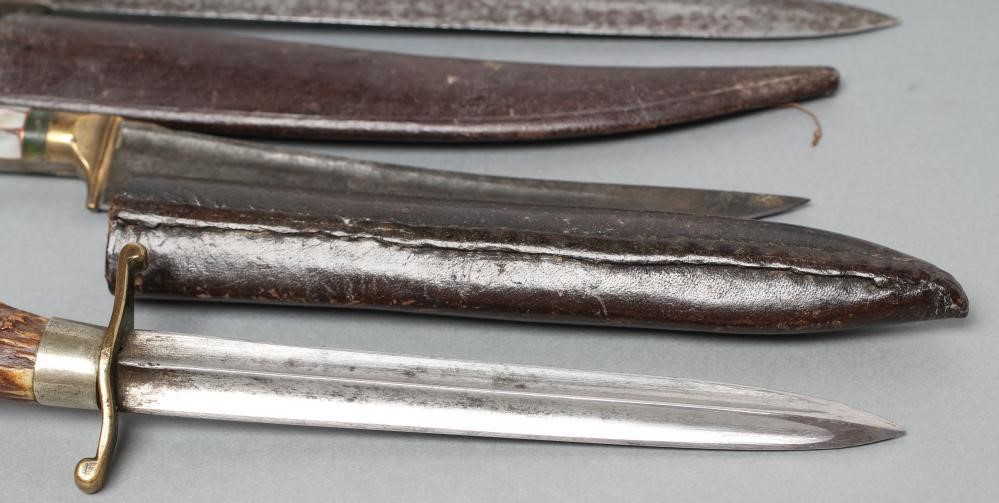 THREE SHEATHED DAGGERS Image