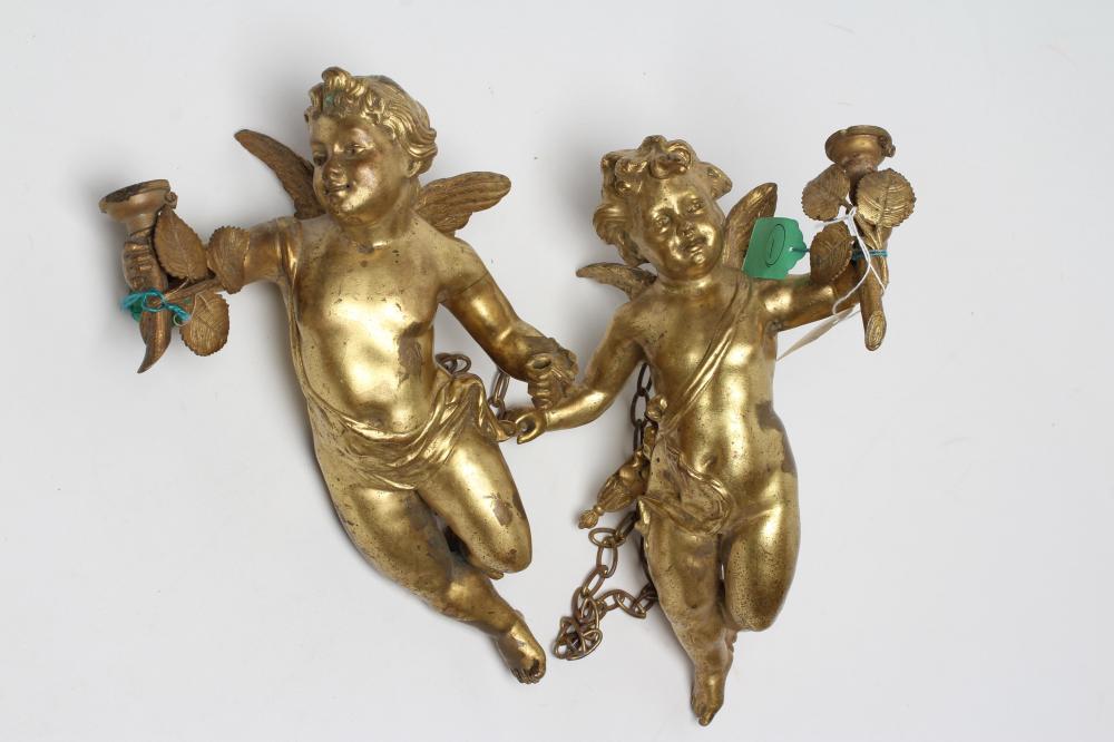 A PAIR OF GILT BRONZE FIGURAL LIGHT PENDANTS in the form of flying cherubs each holding a torch Image