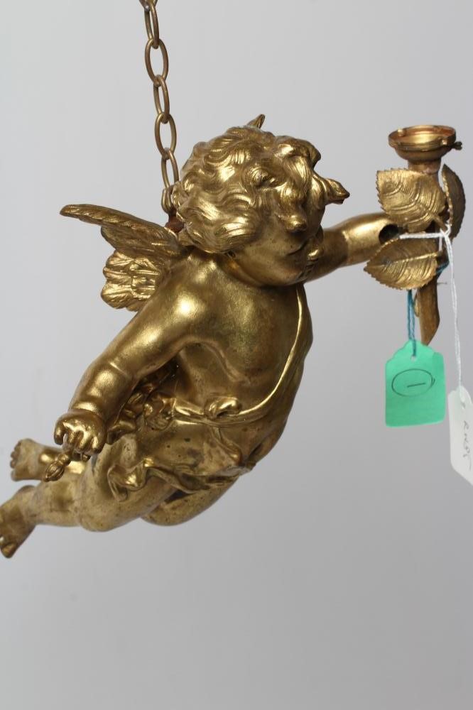 A PAIR OF GILT BRONZE FIGURAL LIGHT PENDANTS in the form of flying cherubs each holding a torch Image