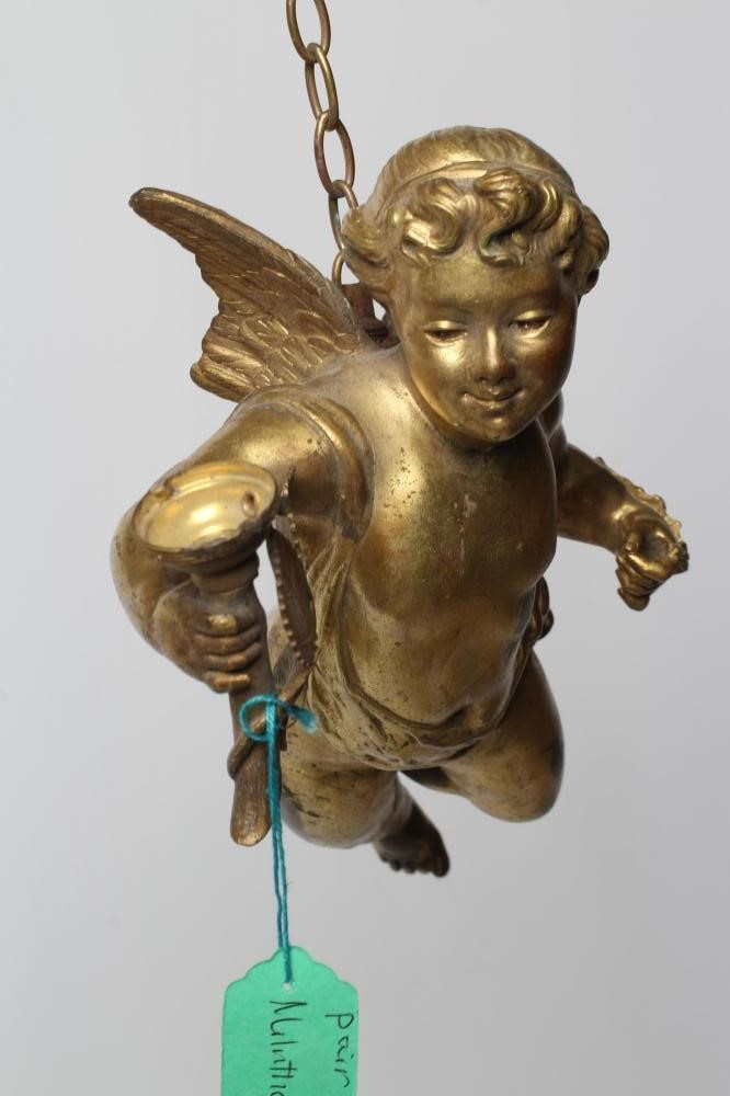 A PAIR OF GILT BRONZE FIGURAL LIGHT PENDANTS in the form of flying cherubs each holding a torch Image