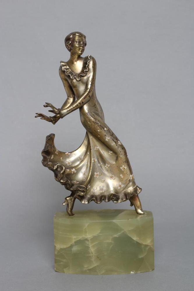 AFTER LORENZL - an Art Deco spelter figure modelled as a young fashionable lady wearing a daisy Image