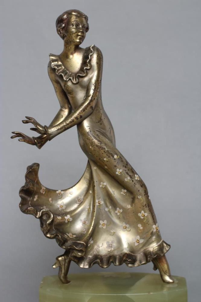 AFTER LORENZL - an Art Deco spelter figure modelled as a young fashionable lady wearing a daisy Image
