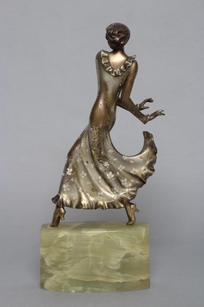 AFTER LORENZL - an Art Deco spelter figure modelled as a young fashionable lady wearing a daisy Image