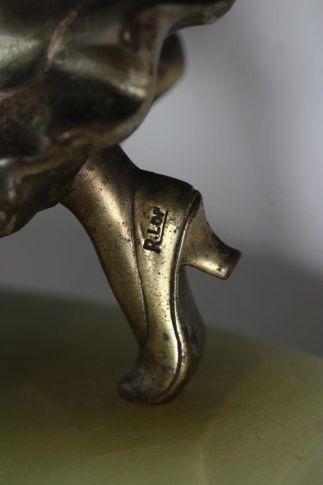 AFTER LORENZL - an Art Deco spelter figure modelled as a young fashionable lady wearing a daisy Image