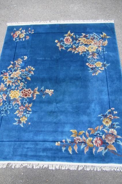 A CHINESE WASHED AND FRINGED BLUE GROUND RUG Image