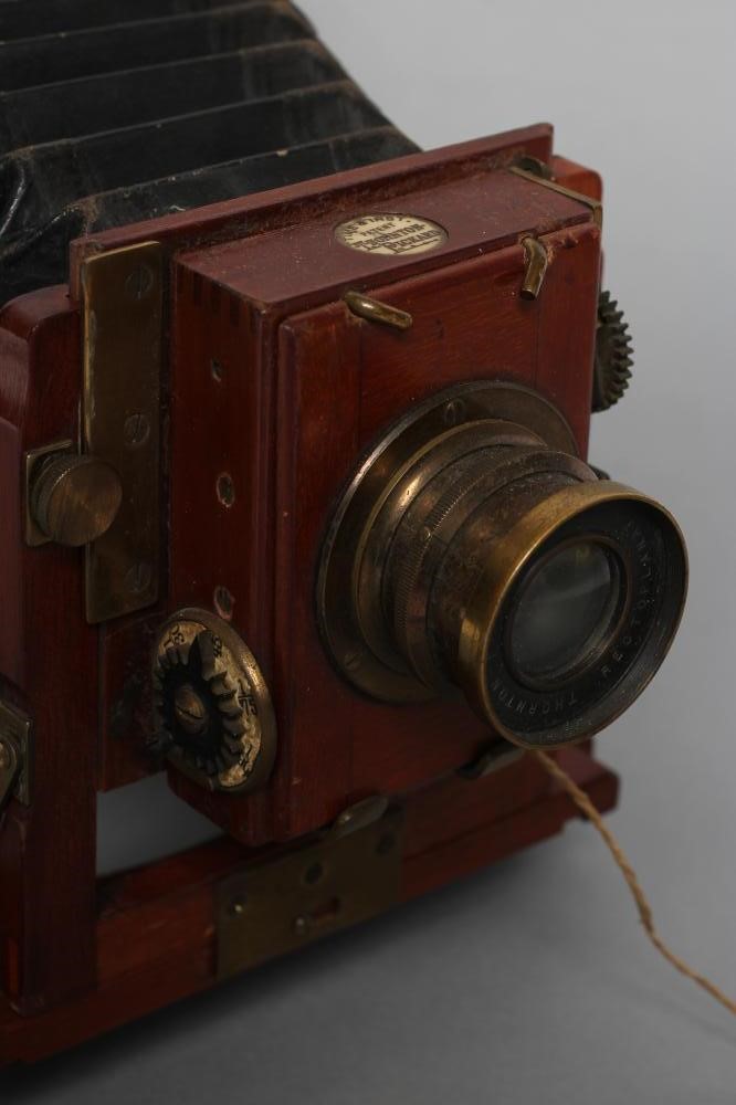 A THORNTON PICKARD "TRIBUNE" FIELD CAMERA of wooden construction with brass fittings and rectoplanat Image
