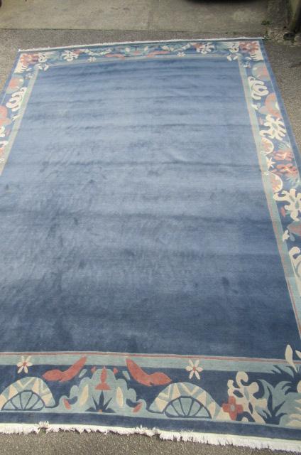 A CHINESE WASHED AND FRINGED CARPET Image