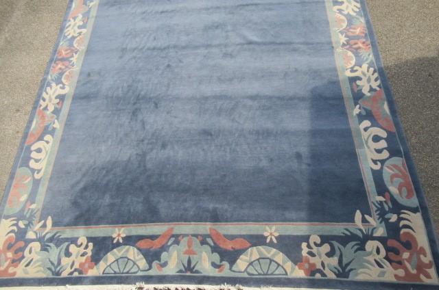 A CHINESE WASHED AND FRINGED CARPET Image