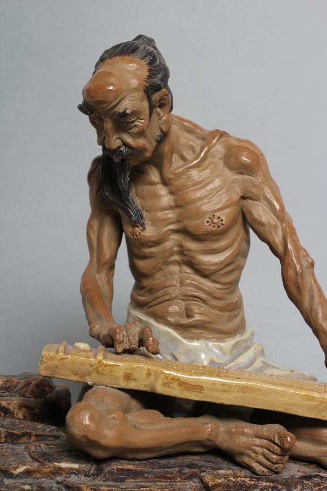 A CHINESE SHIWAN STONEWARE FIGURE Image